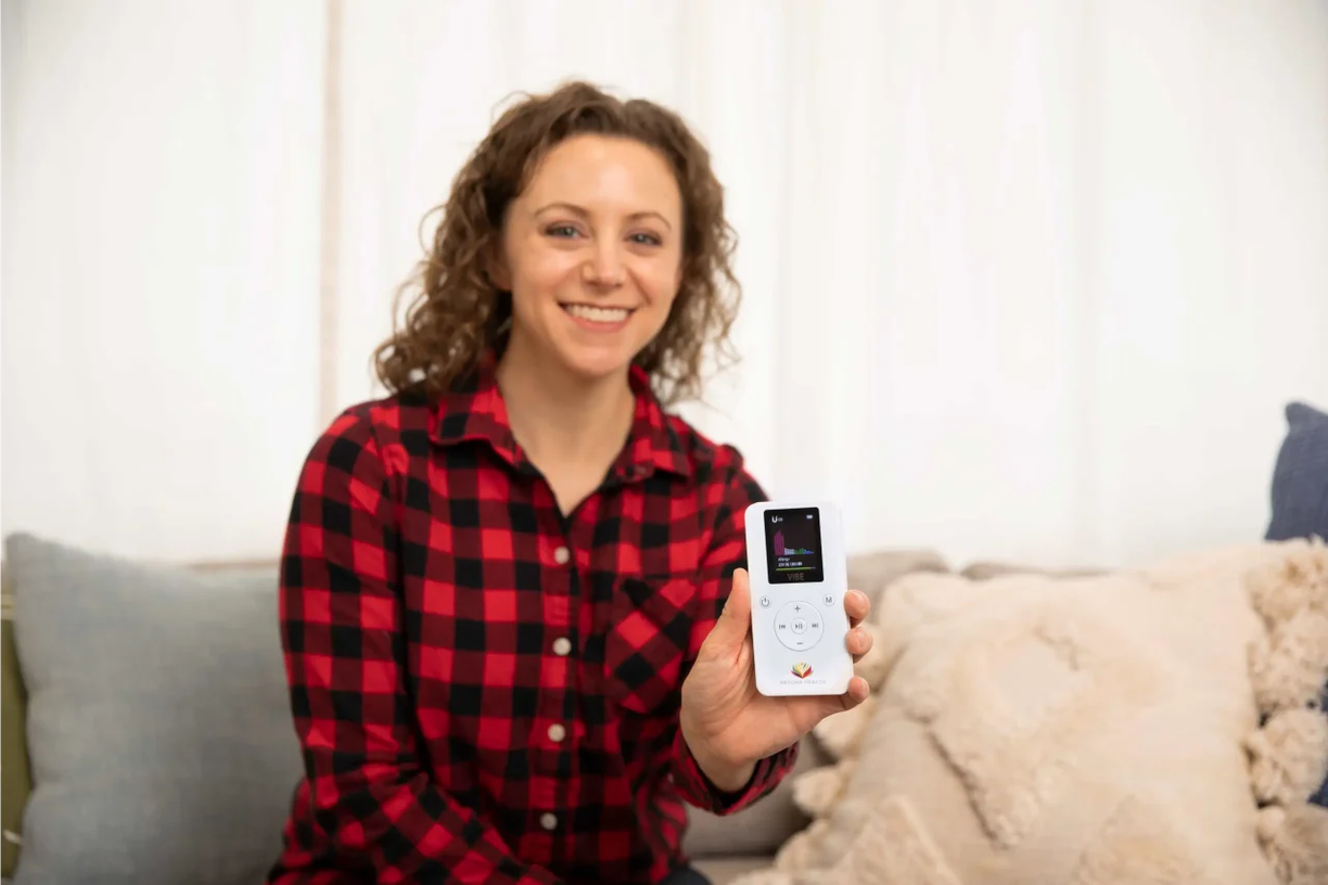 Woman holding Vibe device